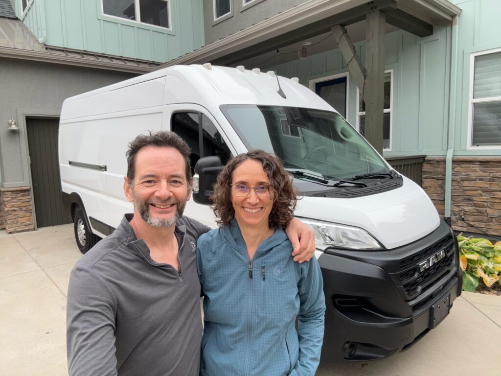 Simon and Amy standing in front of their new van